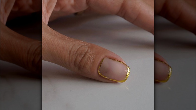 Nails painted with a metallic border 