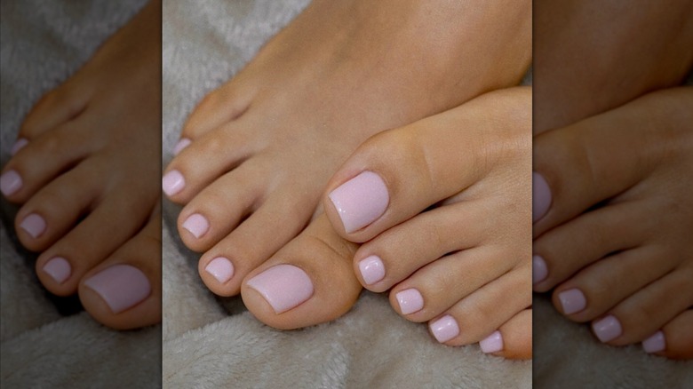 Feet with a light pink nail polish