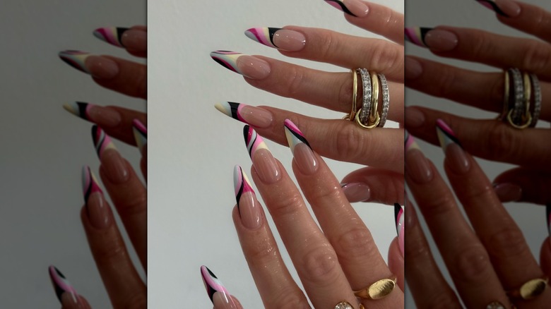 Fingers with rings and Pucci-inspired fingernail designs
