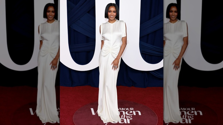 Ciara Miller poses in a white satin dress