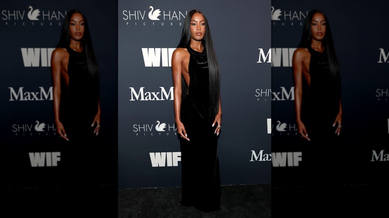 Ciara Miller poses in a velvet maxi dress