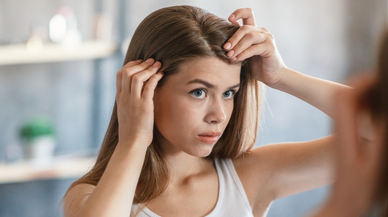 Woman looking at hair part