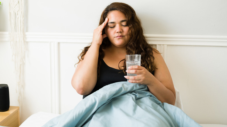 Woman in bed with hangover