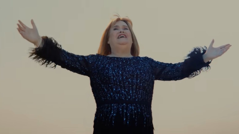 Susan Boyle singing in a blue sequin dress for an Irn Bru commercial