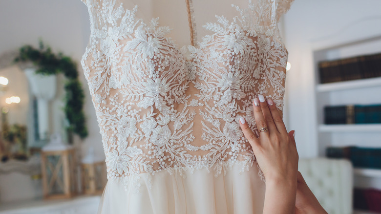 woman holding wedding dress