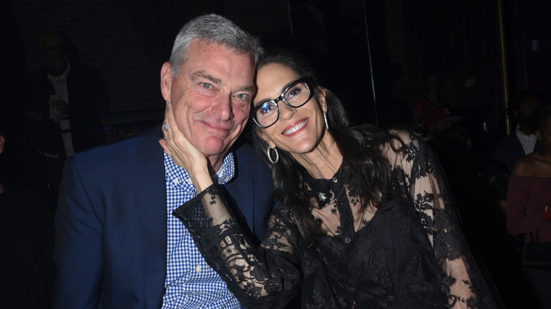Tony Ressler and Jami Gertz sitting and smiling in 2024
