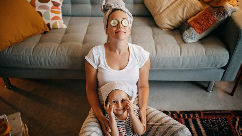 mom doing skincare with child