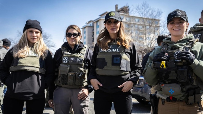 Alina Habba dressed in a bulletproof vest and baseball cap
