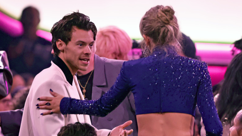 Harry Styles talking to Taylor Swift