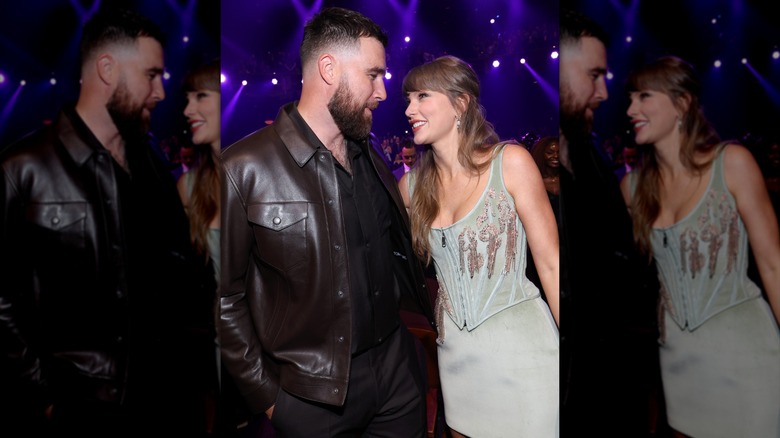 Taylor Swift looking up smilingly at Travis Kelce during the iHeartRadio Music Awards