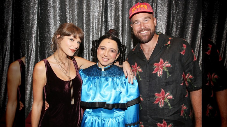 Taylor Swift and Travis Kelce smiling with Maya Rudolph, who's dressed for "Oh, Mary!"