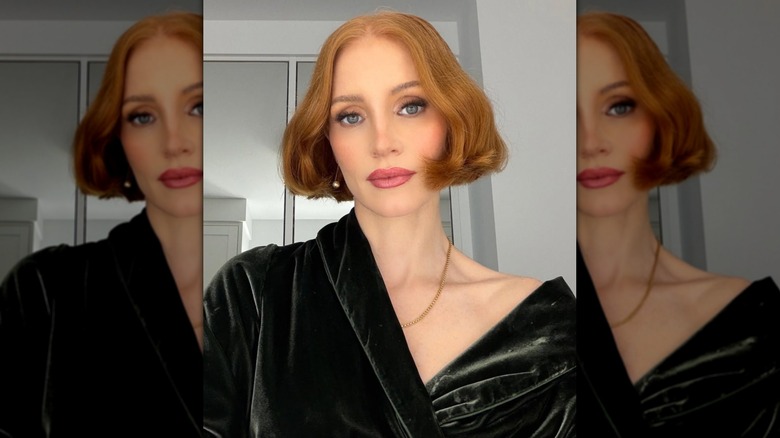 Jessica Chastain wearing a green velvet robe and bobbed hair