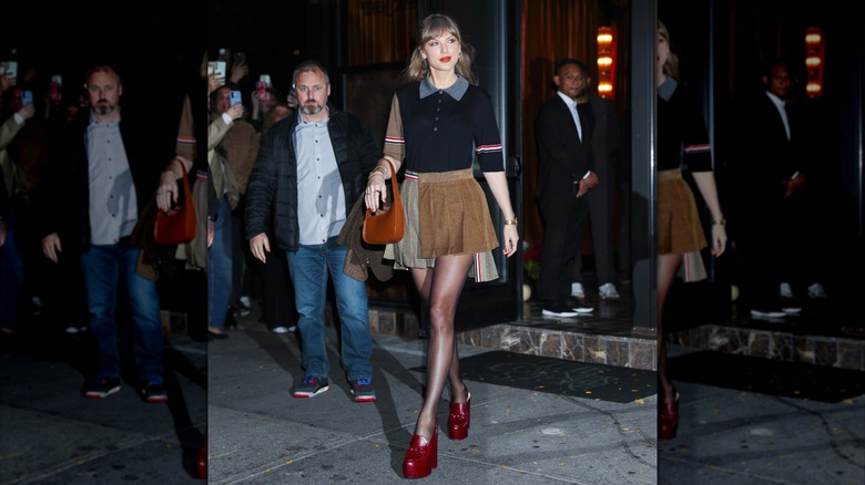 Taylor Swift walking on the street in platform red shoes