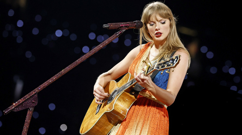 Taylor Swift onstage with an acoustic guitar