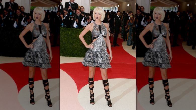 Taylor Swift on the red carpet in a short, silver dress