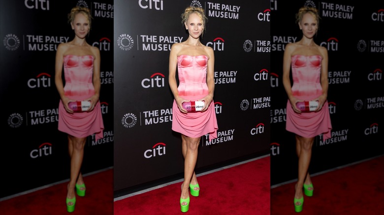 Juno Temple in a pink dress with lime green shoes at an event