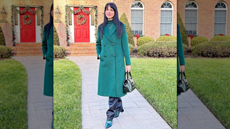 A woman in a long, green coat