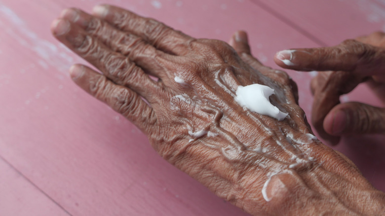 Woman using hand lotion