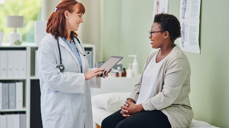 Woman speaking to doctor