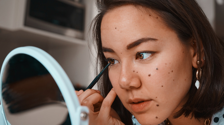 Woman applying makeup