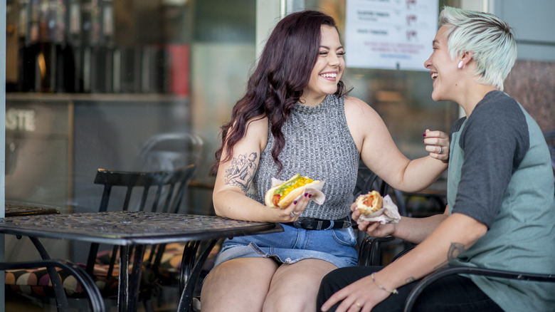 Women eating hotdogs 