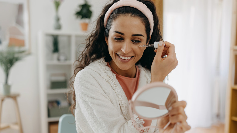 Woman applying serum