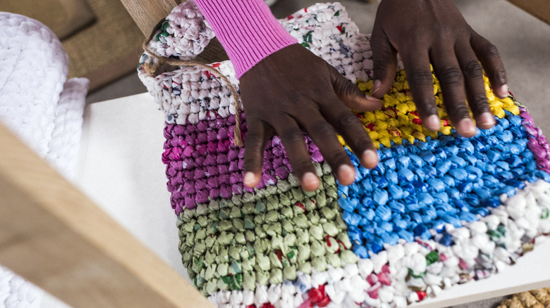 Woman holding colorful woven bag