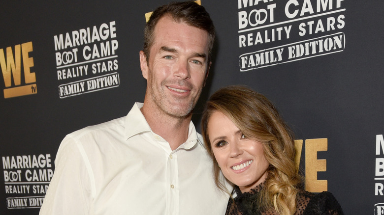 Ryan and Trista Sutter smile on the red carpet in 2019
