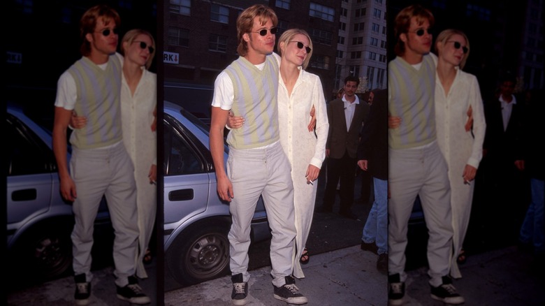 Gwyneth Paltrow and Brad Pitt with their arms around one another and both holding lit cigarettes