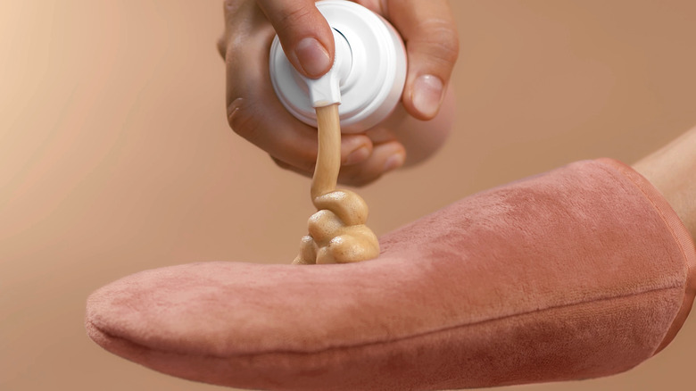 Woman using tanning mousse