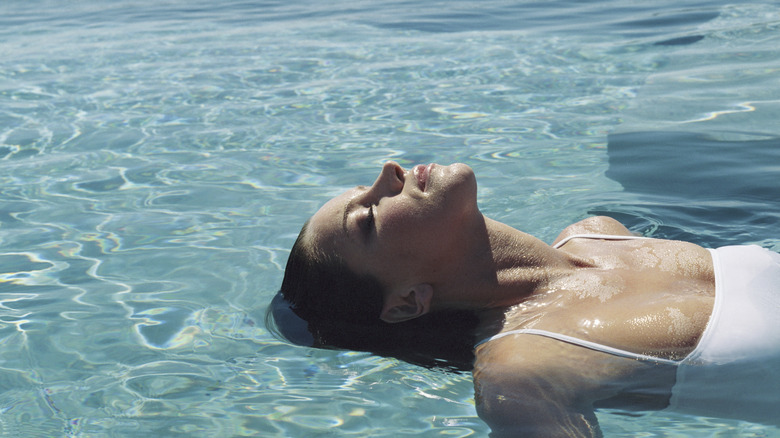 Woman lounging by the pool 