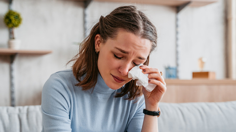 Woman crying with tissue