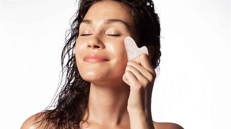 Woman uses gua sha