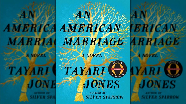 The cover of An American Marriage featuring a blue backdrop and a gold tree