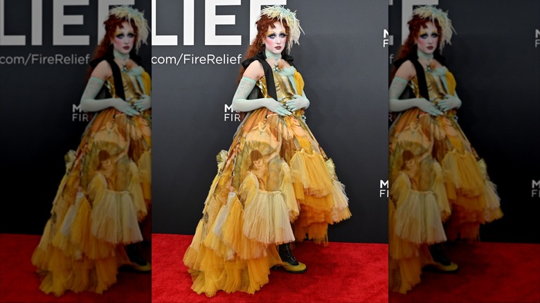 Chappell Roan posing at the 2025 Grammy Awards while wearing a vintage-inspired Jean Paul Gaultier dress