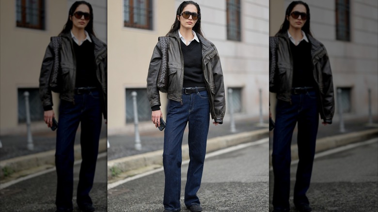 Woman wearing a leather jacket and straight but loose dark jeans