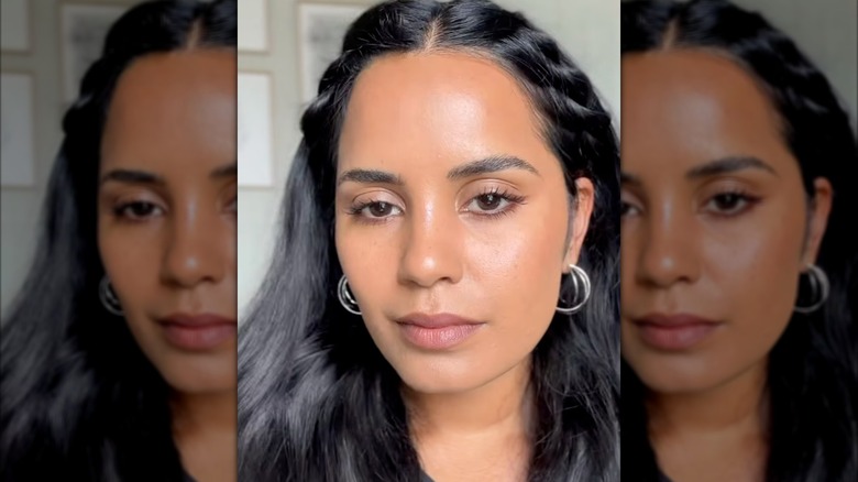 A woman wearing brown eyeliner and braids with long hair on Instagram
