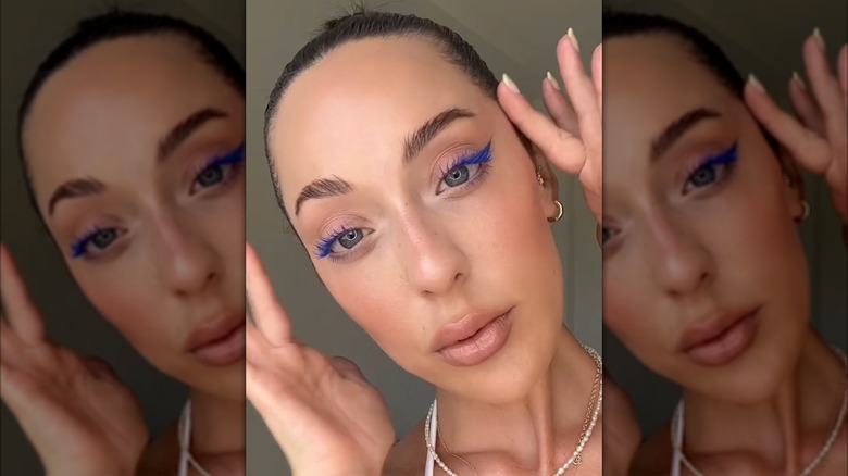 A woman with electric blue liner