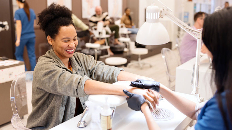 Woman at the nail salon smiling