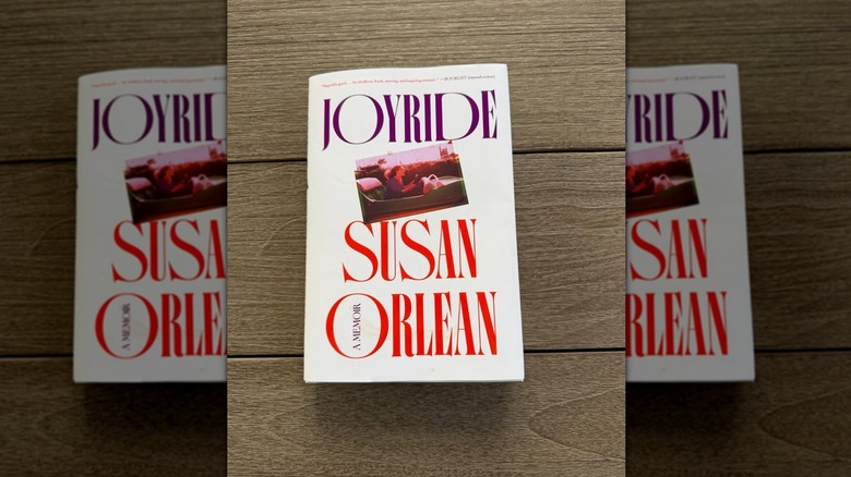 A copy of Joyride by Susan Orlean laying on a wooden table