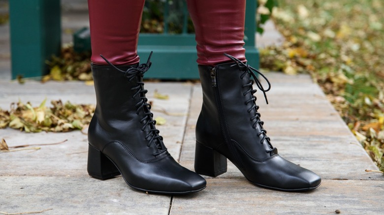 A woman wearing low block heel boots