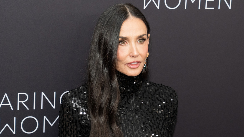 Demi Moore on the red carpet in a black sparkling dress