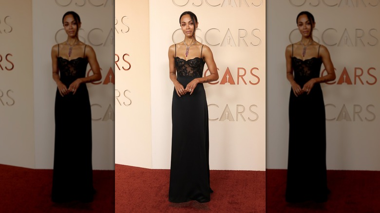 Zoe Saldaña on the red carpet in a lacy black dress
