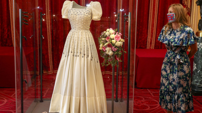 Princess Beatrice posing beside her wedding dress