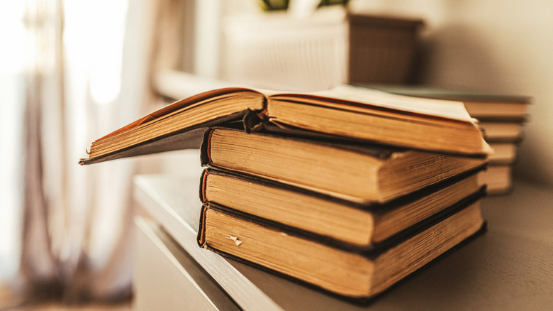 Weathered book sitting open on a book stack