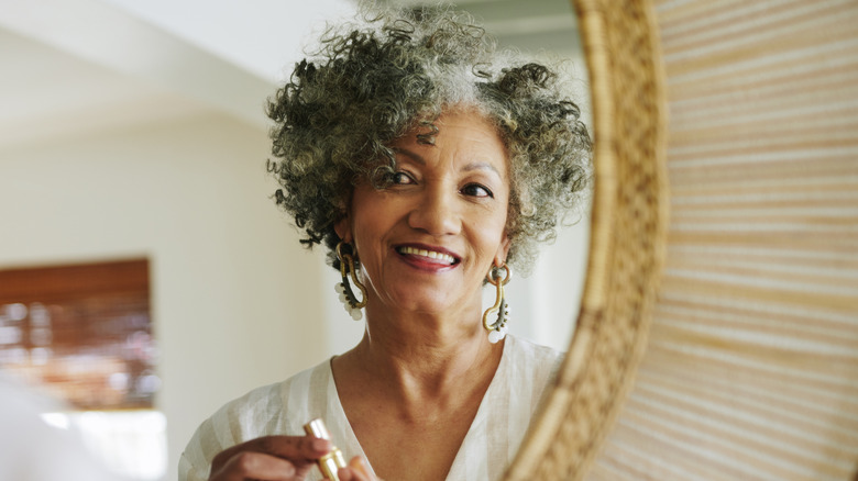 older woman looking in the mirror