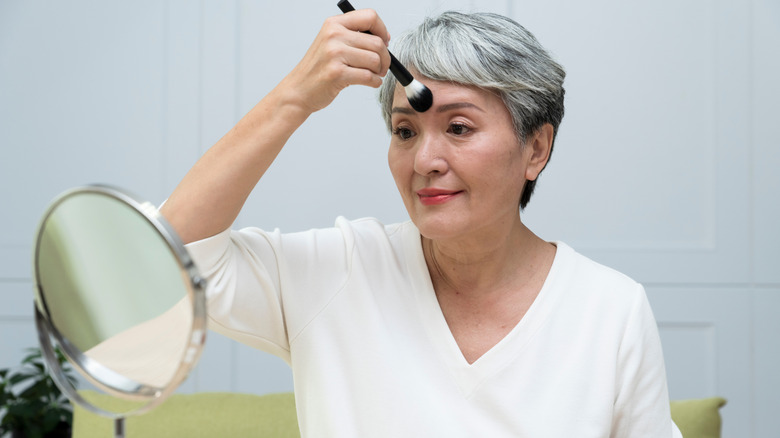 Older woman brushing her t-zone