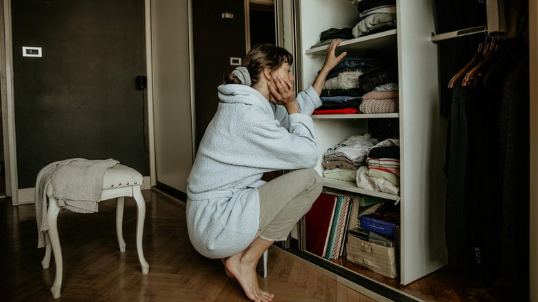 A woman looking in her closet