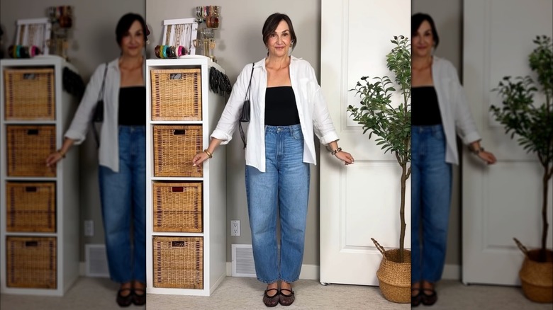 A woman wearing barrel jeans with mesh ballet flats