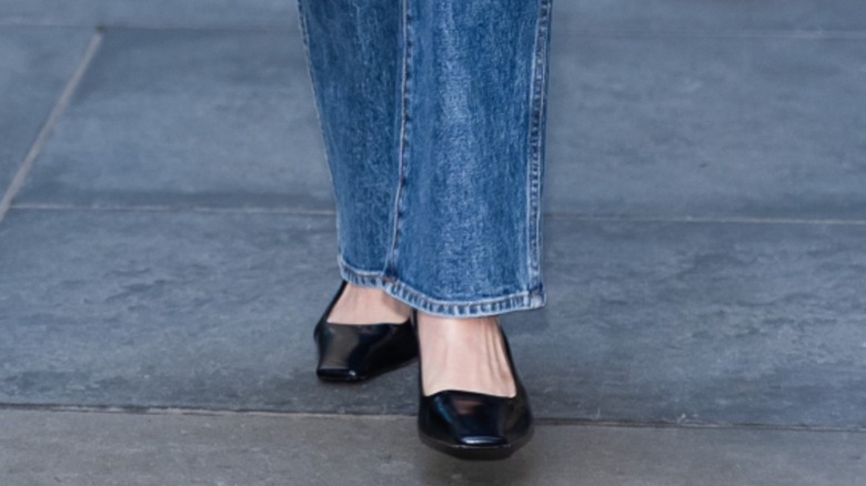 Olivia Munn's black pumps with blue stovepipe jeans